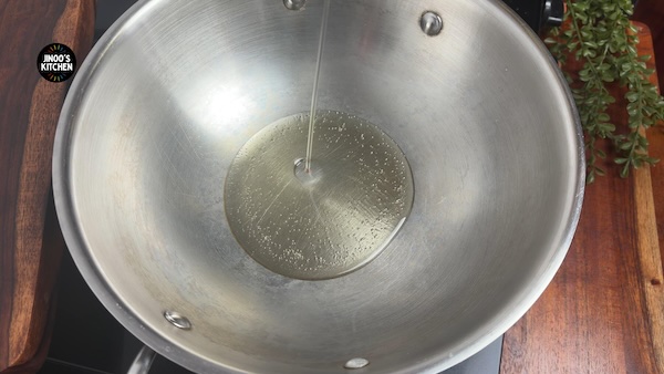Mustard seeds crackling in sesame oil in a pressure cooker