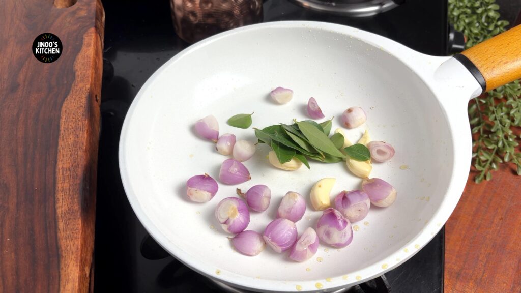adding the small onions to the pan
