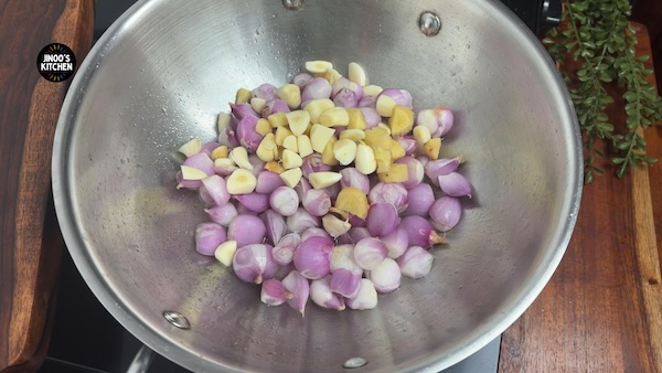 Small onions, ginger and garlic frying in sesame oil for Kongu chicken curry