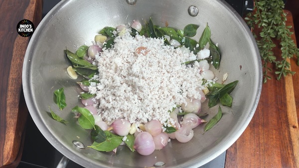 Grated coconut added with onions and curry leaves for chicken masala